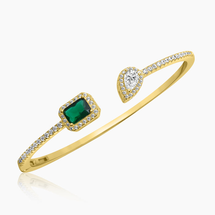 A silver bracelet with green and clear zircon stones, featuring a gold E-coat and a sophisticated design.