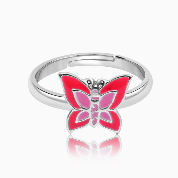 A silver ring with a central pink butterfly detail, surrounded by a simple, polished band.