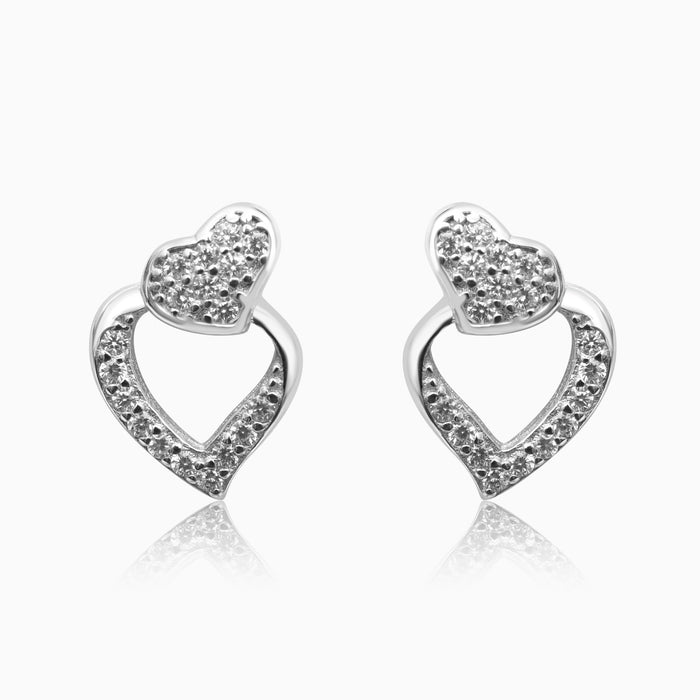 A pair of silver heart-shaped earrings with sparkling zirconia stones