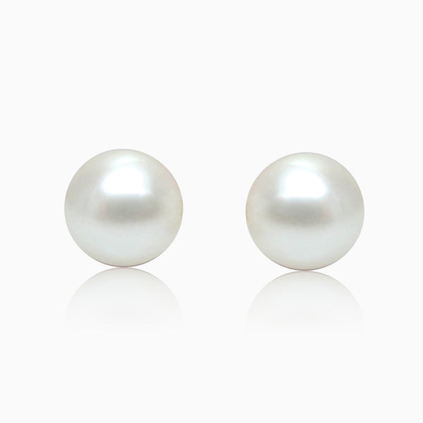A pair of silver button pearl earrings with a rhodium finish.