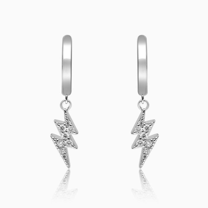A pair of silver hoop earrings with lightning charm pendants.