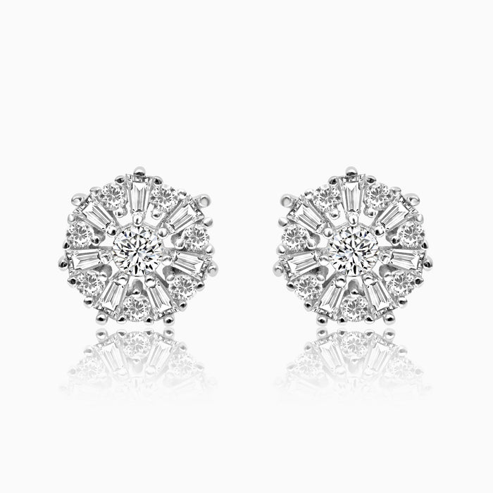 A pair of silver shimmer laurel flower pendants set in a reflective surface.
