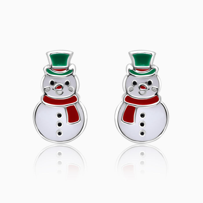 A pair of silver kids' earrings shaped like snowmen with green and red hats.