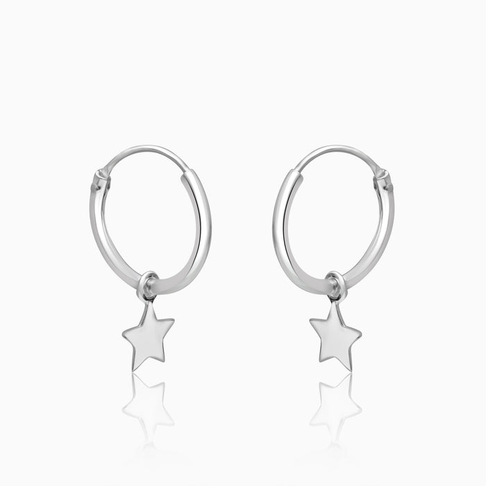 A pair of silver-plated star-shaped hoop earrings with a rhodium finish.