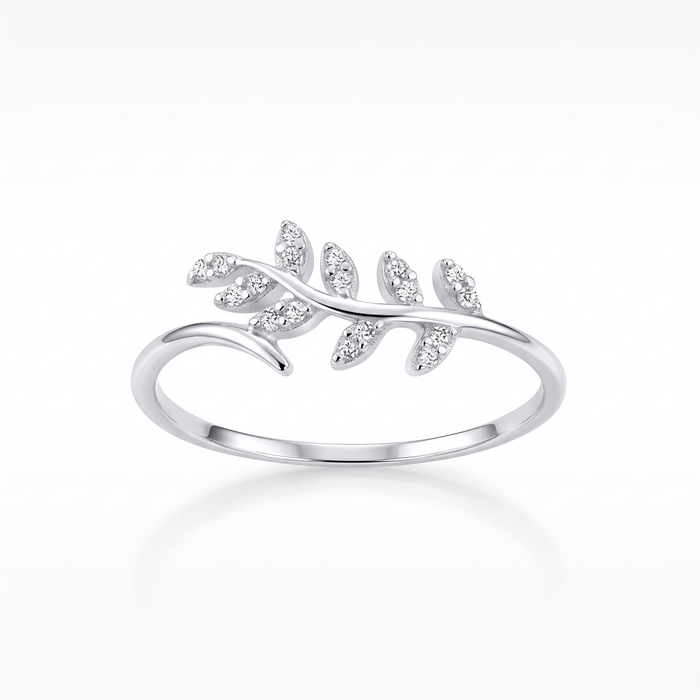 A silver ring featuring a delicate leaf branch design set with small clear marquise-cut stones, shown on a clean white background with a soft reflection.