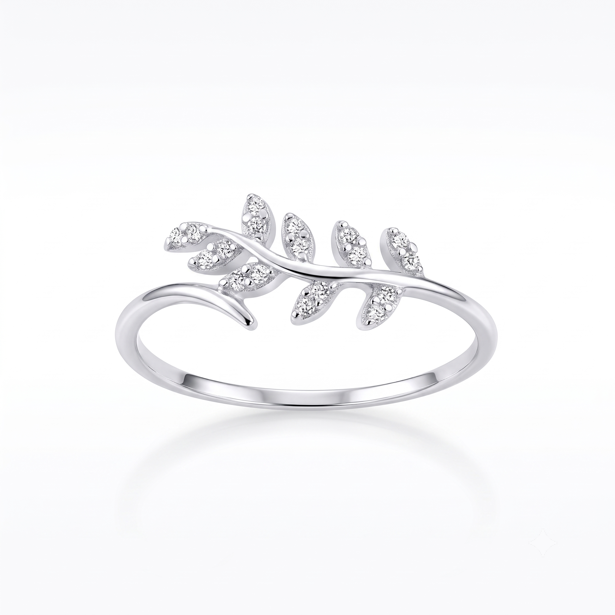 A silver ring featuring a delicate leaf branch design set with small clear marquise-cut stones, shown on a clean white background with a soft reflection.