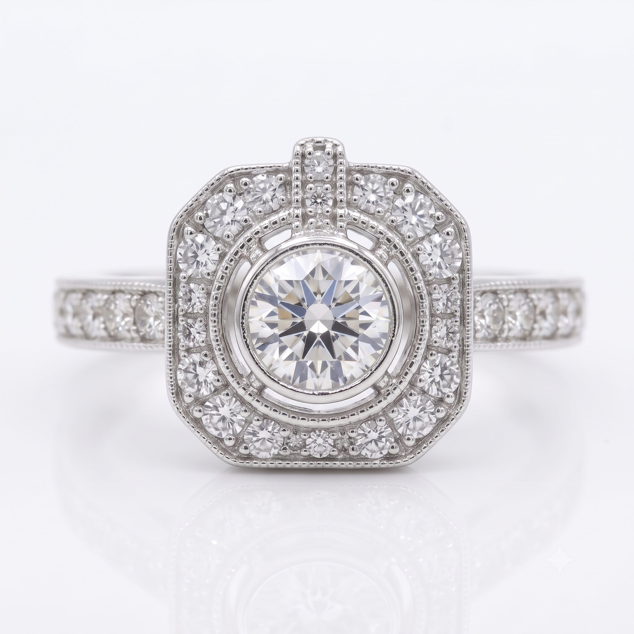An octagonal diamond ring featuring a round center stone surrounded by double rows of small diamonds, with a milgrain-set band, shown on a white background with a soft reflection.