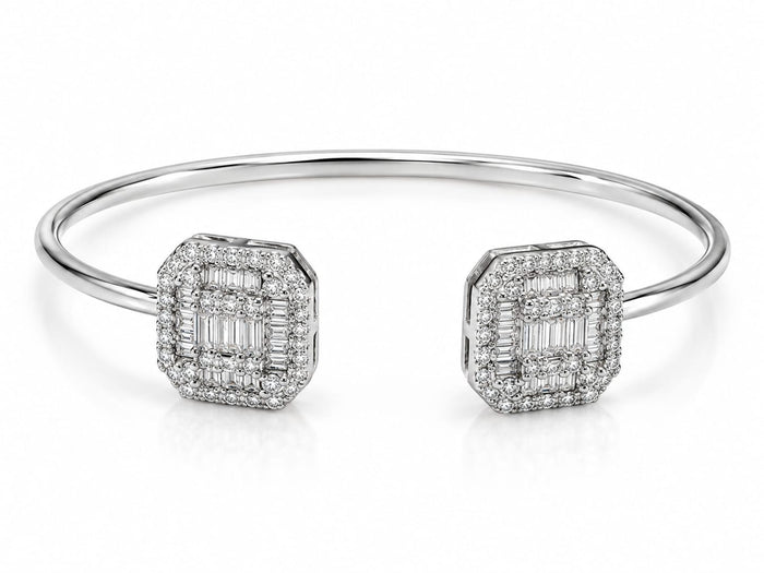 A polished silver-tone cuff bracelet featuring two square-shaped pavé diamond end caps with baguette-cut center stones, set against a clean white background.
