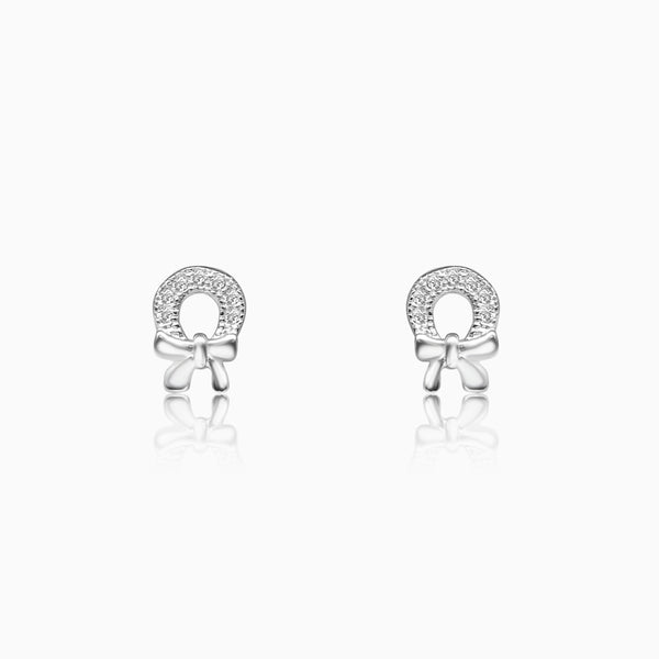 A pair of silver horseshoe bow earrings with sparkling rhinestones.