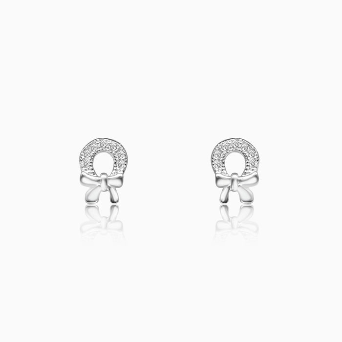 A pair of silver horseshoe bow earrings with sparkling rhinestones.
